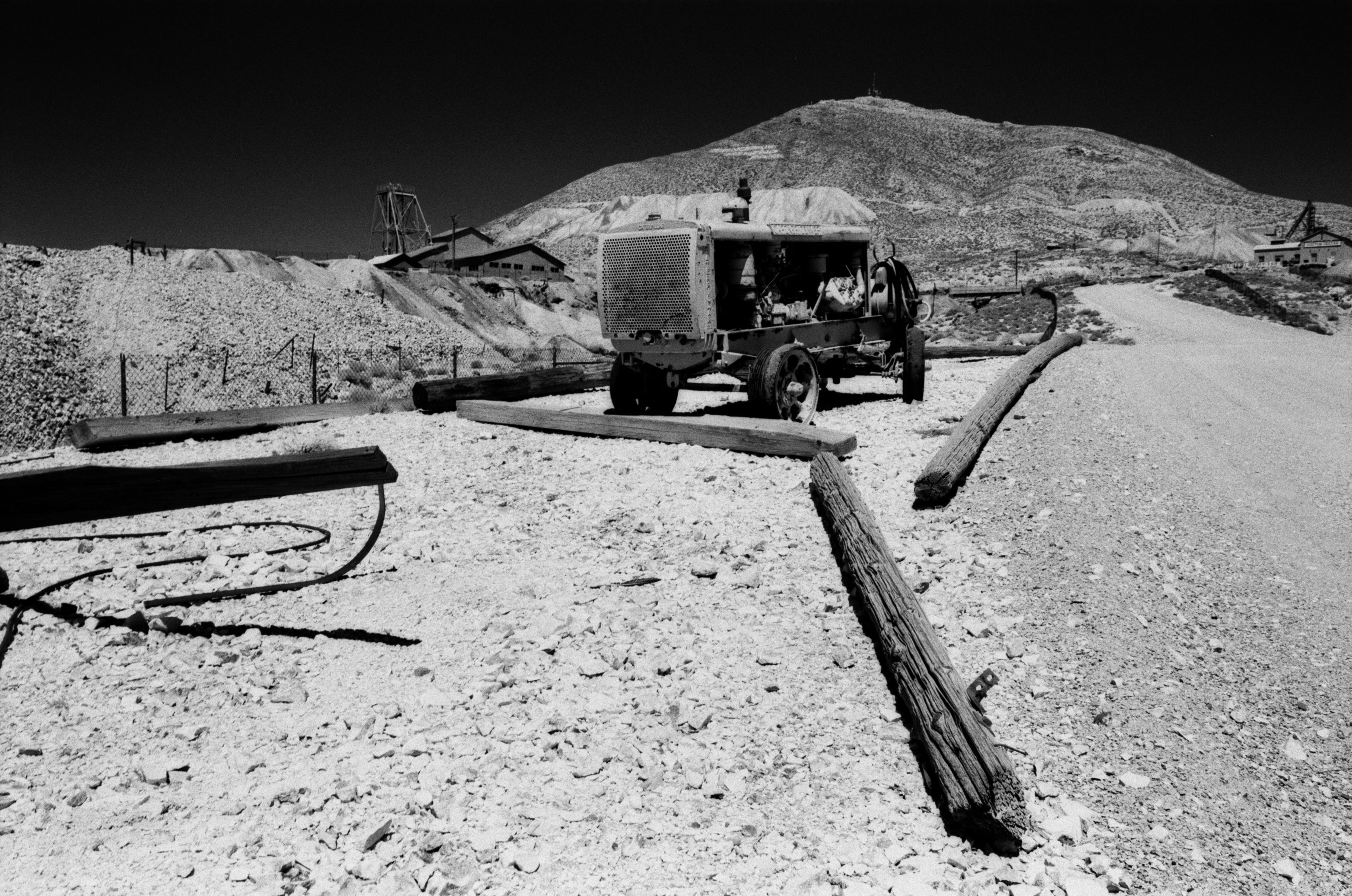 Vintage truck on a dirt road with mountains in the background